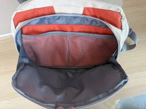 Detail view of multi-pocket internal compartments, breathable mesh design, ideal for outdoor tackle storage.