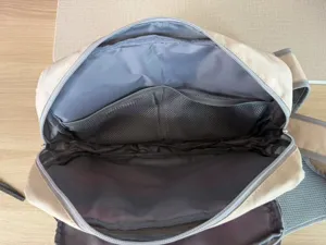 Fly fishing chest pack interior detail showing mesh zipper pockets and spacious tackle storage.
