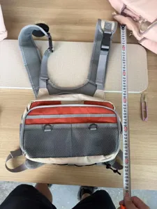 Outdoor multi-functional fly fishing chest pack vest with breathable mesh shoulder straps and pockets.