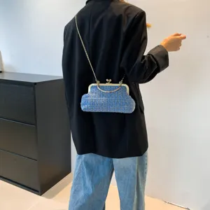 Vintage blue tweed chain shoulder bag for women with gold hardware shown on model