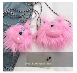 Close-up detail of two pink furry monster plush crossbody bags with pigtails
