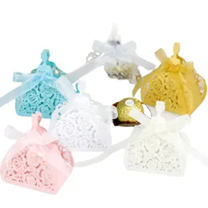 Laser-cut princess dress wedding favor boxes with hollow rose patterns and ribbons