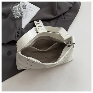 Interior detail of a punk-style hobo bag showing spacious compartments and zip pocket