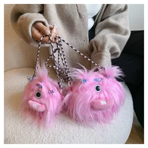 Detail shot of two pink furry monster plush crossbody bags with braided straps