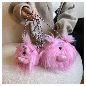 Detail shot of pink fuzzy monster crossbody bag with unique ugly-cute plush design.
