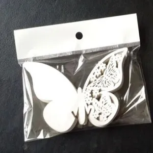 Detailed view of ice white laser-cut butterfly place cards in protective packaging
