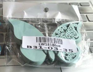 Close-up of 3D laser-cut blue butterfly seat cards in their retail packaging bag.