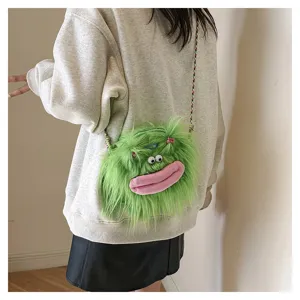 Close-up of a green furry monster plush crossbody bag styled with a grey sweatshirt