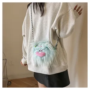 Close-up detail of a blue plush monster crossbody bag with braided fur and funny face