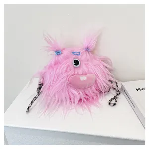 Close-up detail of a pink fuzzy monster plush bag with long hair and pigtails