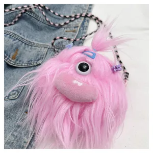 Macro view of pink fuzzy monster plush crossbody bag with unique eye and clips