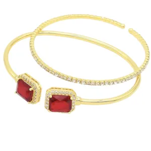 Gold open cuff bracelet set with red square cubic zirconia and sparkling crystal pavé details.