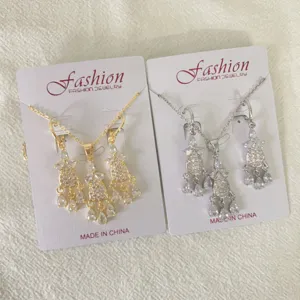 Details of the vintage zircon dreamcatcher tassel necklace and earrings jewelry set in gold and silver.