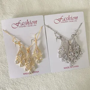 Elegant tassel earrings and necklace jewelry set featuring micro-pave cubic zirconia design.
