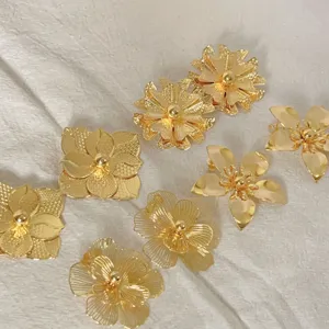 Gold plated flower earrings detailed view, luxury Middle Eastern style jewelry design for women banquet.
