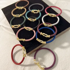 Colorful braided leather bracelet with crystal horseshoe buckle, stylish couple jewelry gift.
