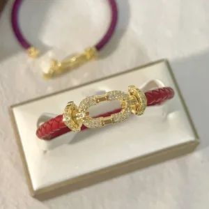 Red braided leather bracelet detail shot with gold pavé crystal buckle clasp for daily wear.