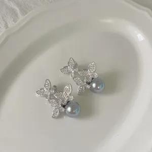 Prachtige zilverkleurige zirkonia vlinder oorbellen met elegante grijze parels voor dames.