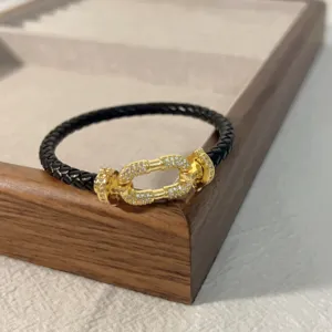 Black braided leather bracelet with gold pave diamond horseshoe clasp for men and women couple