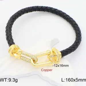 Detail view of black braided leather bracelet with gold pave shackle clasp and stones.