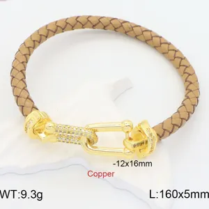 Braided leather bracelet with gold-tone U-shackle clasp and pavé cubic zirconia for couples.