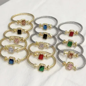 Detailed close-up of luxury twisted cable cuff bracelets with colorful square zircon stones.