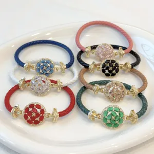 Multi-color braided leather rope bracelets with 18k gold plated zircon flower charms.