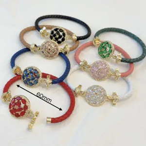Luxury 18K gold plated braided leather bracelet with multi-color round cubic zirconia crystals.