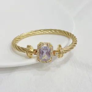 Close-up of vintage gold-plated cable bracelet with sparkling rectangular zircon stone.