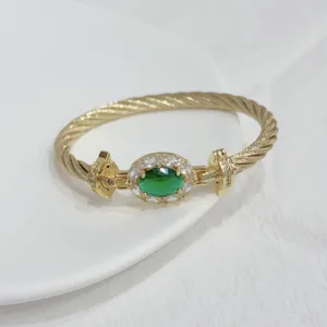 Exquisite detailed shot of the 18k gold plated twisted cable green stone bracelet.