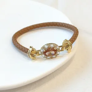 Elegante bracciale in pelle intrecciata con zircone ovale e chiusura placcata oro 18k vintage.