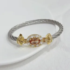 Luxurious 18k gold plated twist cable bracelet with oval champagne zircon for women.