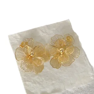 Gold plated stainless steel hollow flower earrings, exaggerated petal design for banquet luxury.