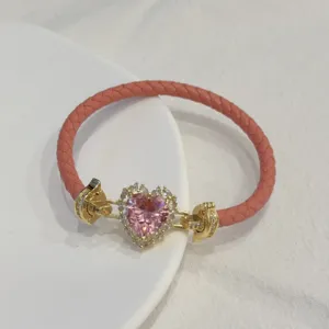 Pink braided leather bracelet with gold-plated heart zircon clasp fashion jewelry detail