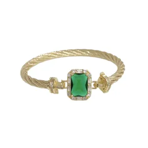 Vintage gold-plated cable cuff bracelet with green emerald cubic zirconia stone and sparkling pave.