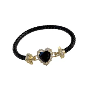 Elegant black braided leather bracelet with gold plated heart cubic zirconia charm for women.