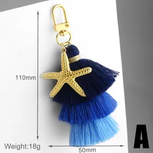 Blue gradient tassel keychain with gold starfish pendant, stylish bag charm accessory.