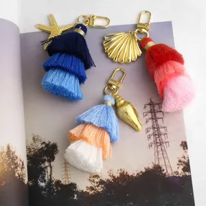 Multi-layer tassel keychain with gold seashell and starfish charms, stylish bag pendant accessory.