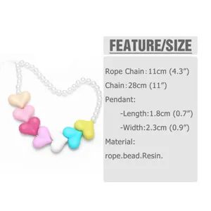 Detailed view of the colorful heart pendant and imitation pearl mobile phone chain accessory.