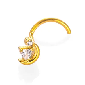 Close-up detail view of gold titanium alloy moon and zircon nose stud body piercing ring.