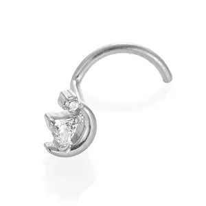 Close-up detail of titanium nose stud with moon and heart zircon, body piercing jewelry.