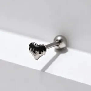 Stainless steel heart tongue ring detail, black drip body piercing jewelry close up