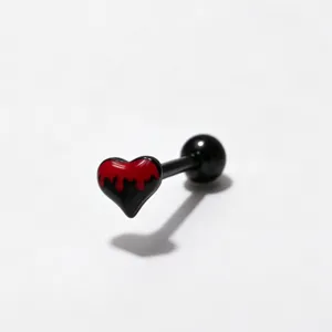 Detailed shot of a black and red dripping heart tongue ring body piercing jewelry piece.