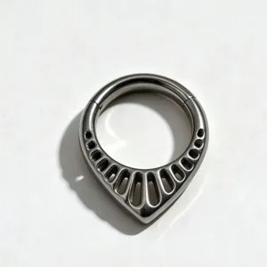 Detailed view of the F136 titanium teardrop septum clicker piercing ring with cutout design.