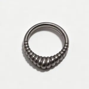 Detail shot of F136 titanium alloy hinged segment piercing ring with ribbed design for nose and ears.