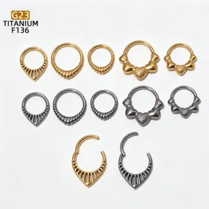 Detailed view of G23 titanium clicker rings, featuring various droplet and heart shapes.