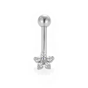 Detailed view of 316L stainless steel curved navel piercing with cubic zirconia flower