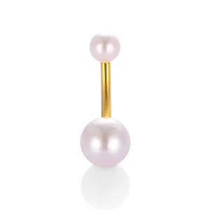 Close-up detail shot of the elegant gold-toned curved bar navel piercing with dual pearls.