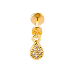 Gold titanium steel labret piercing detail, featuring a clear paved zirconia teardrop pendant.