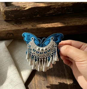 Traditional ethnic style embroidered butterfly tassel hair clip with silver-colored metal charms.